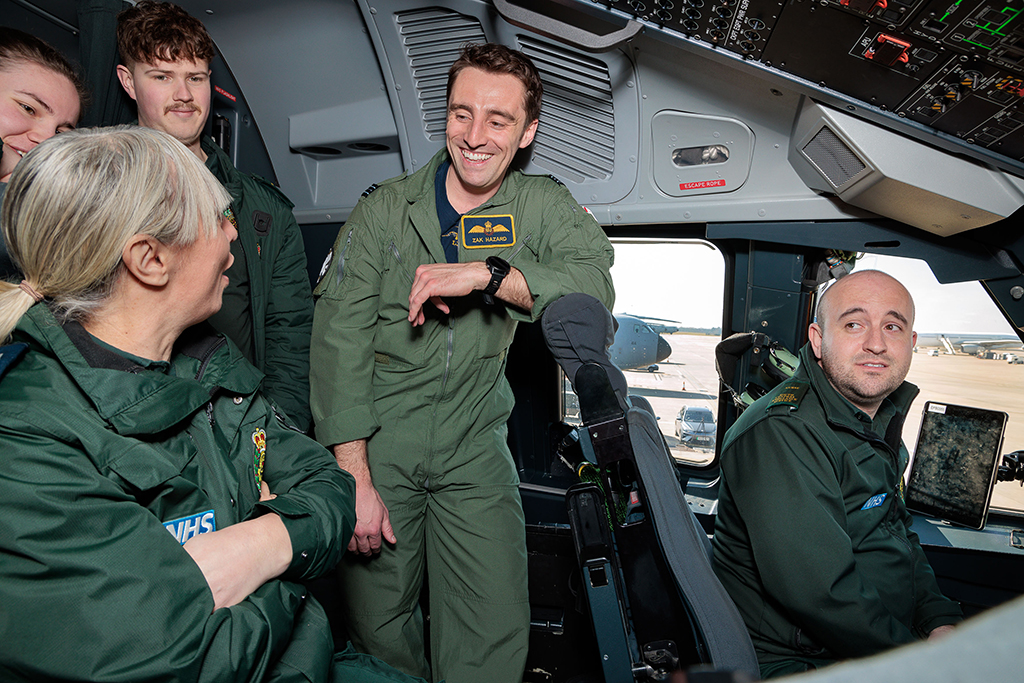 Members of the South Central Ambulance Service receive a briefing, whilst standing on the flight deck of an Atlas C Mk.1